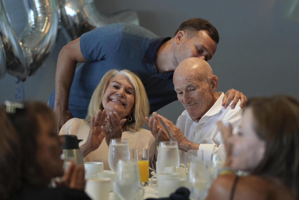 Tyler Terens kisses his grandfather Harold Terens, a World War II veteran who fought in D-Day. after speaking at his 102 birthday party, Saturday, July 26, 2025, in Delray Beach, Fla. 