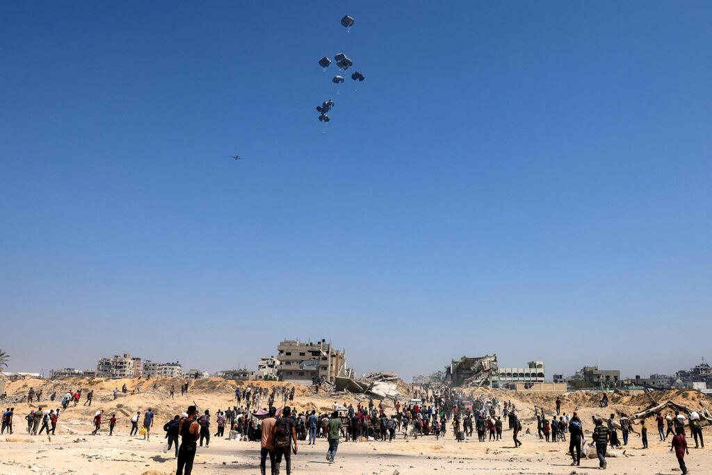 Photo: Bashar Taleb / AFP חלוקת סיוע הומניטרי ברצועת עזה