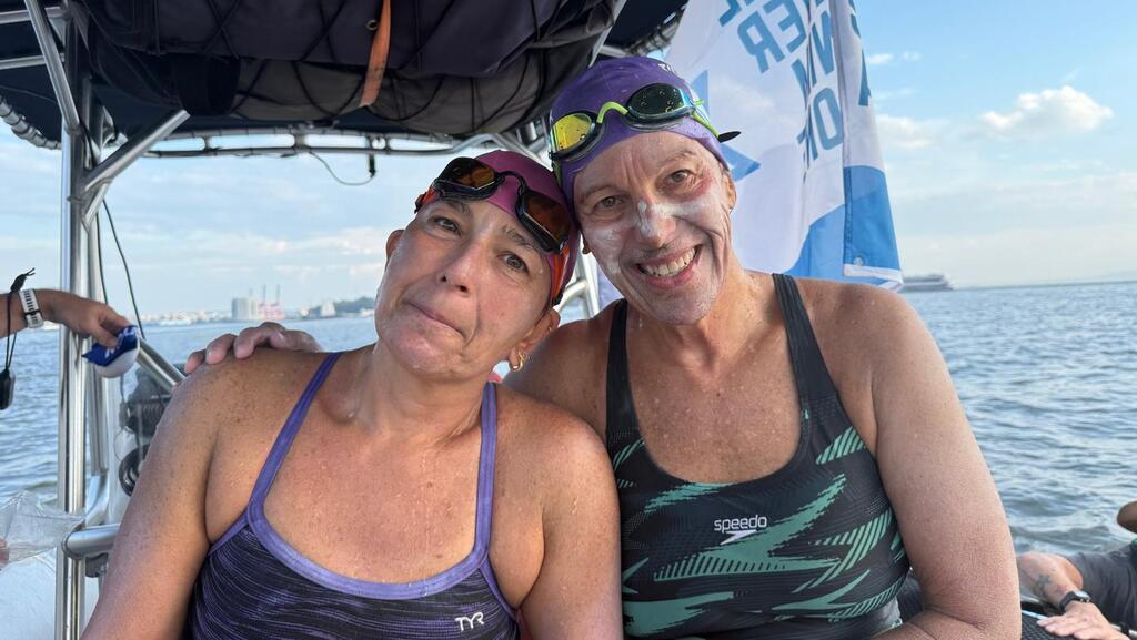 Debbie and Anat preparing for the Manhattan swim; 'This group helps me cope with the immense loss'