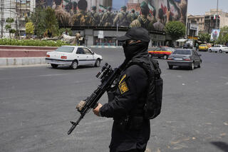 A member of Iran's Revolutionary Guard stands guard at Enqelab-e-Eslami (Islamic Revolution) square in downtown Tehran 