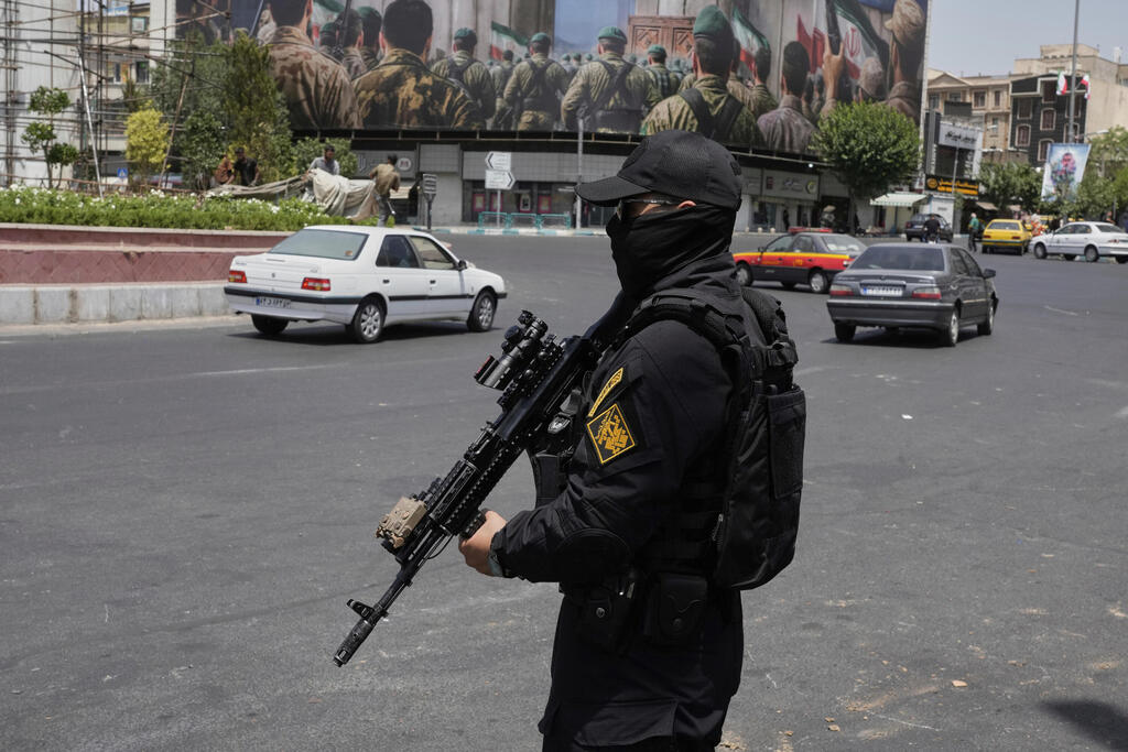 A member of Iran's Revolutionary Guard stands guard at Enqelab-e-Eslami (Islamic Revolution) square in downtown Tehran (Photo: Vahid Salemi / AP) A member of Iran's Revolutionary Guard stands guard at Enqelab-e-Eslami (Islamic Revolution) square in downtown Tehran