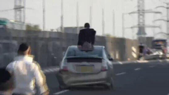 חרדי על גג רכב נוסע