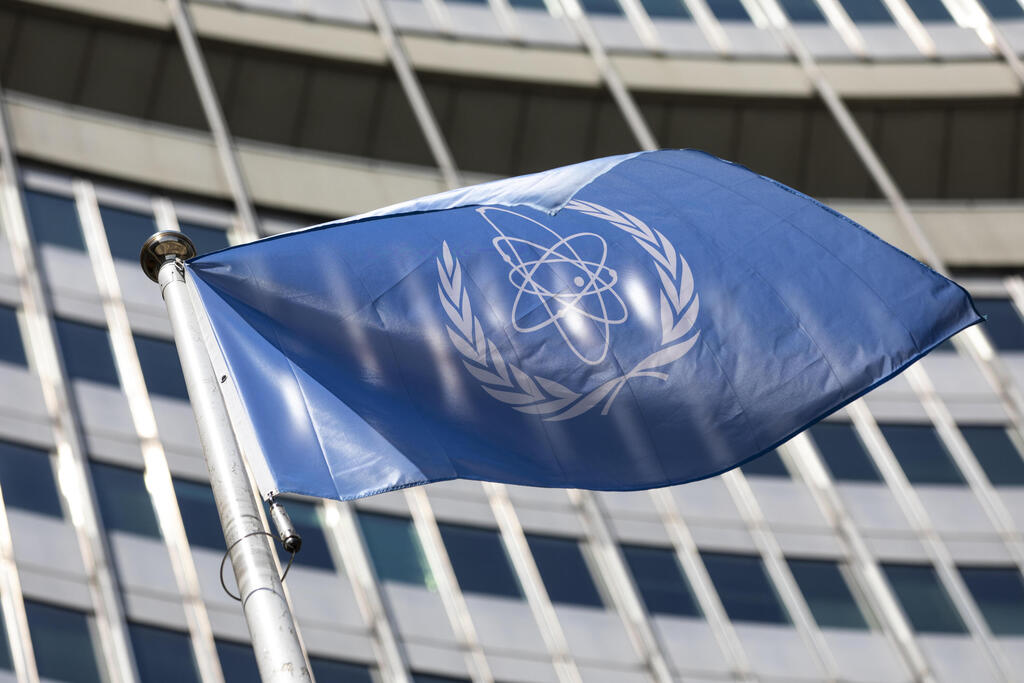 In this June 7, 2021, file photo, the flag of the International Atomic Energy Agency (IAEA) waves at the entrance of the Vienna International Center in Vienna 