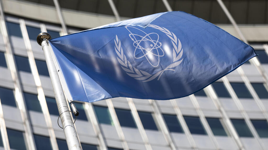 In this June 7, 2021, file photo, the flag of the International Atomic Energy Agency (IAEA) waves at the entrance of the Vienna International Center in Vienna 