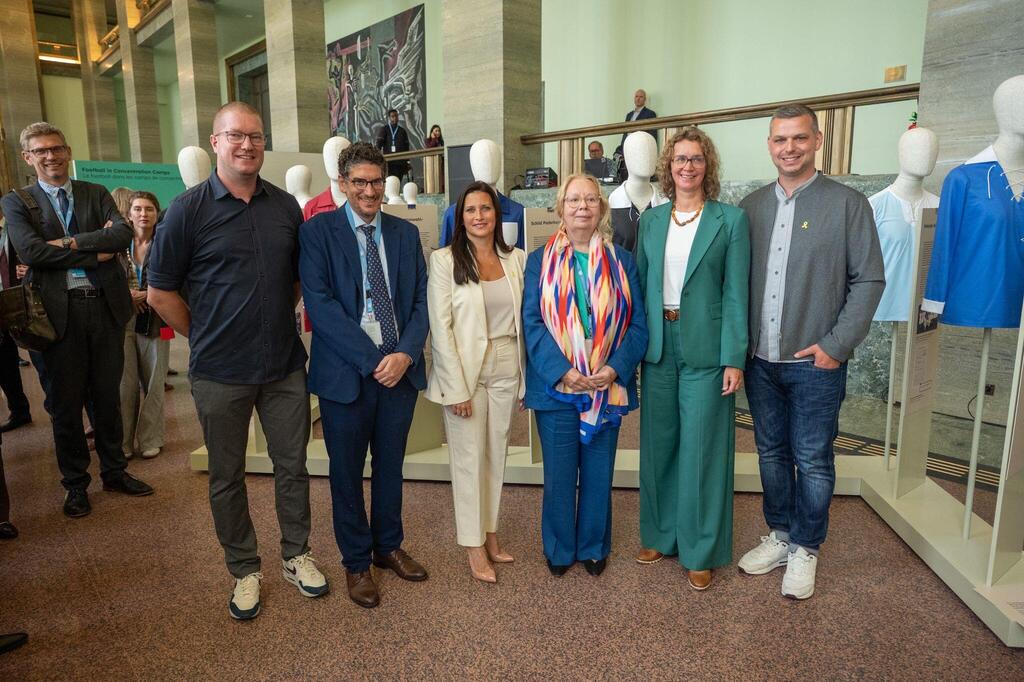 Organizers and diplomats pose during the opening of the exhibition 'Sports. Crowds. Power.' at the United Nations Palais des Nations in Geneva on Sept. 8, 2025 