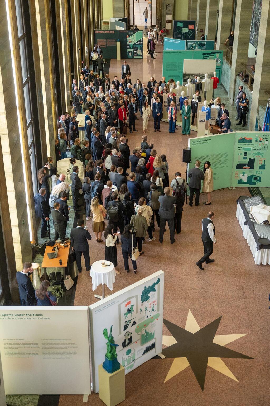 Visitors gather at the opening of the exhibition 'Sports. Crowds. Power.' at the United Nations Palais des Nations in Geneva on Sept. 8, 2025 