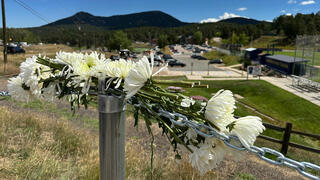 Flowers are left in remembrance of those wounded in a shooting at Evergreen High School in Evergreen, Colo.