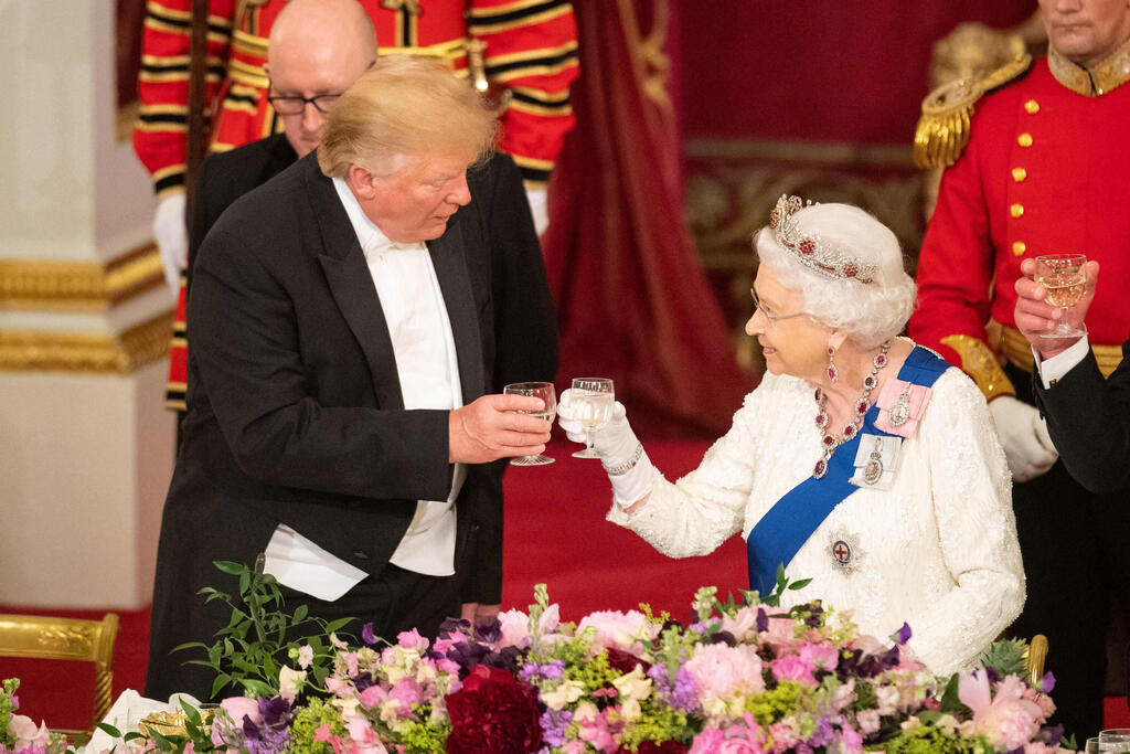 Britain's Queen Elizabeth II raises a glass with US President Donald Trump during a State Banquet in the ballroom at Buckingham Palace during his first state visit in 2019