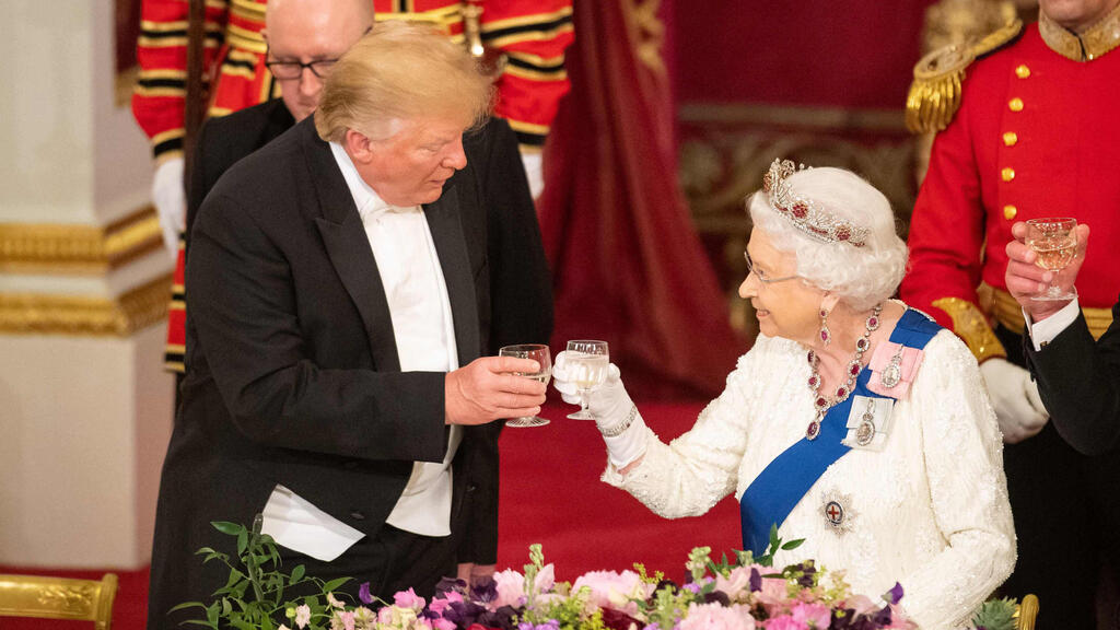 Britain's Queen Elizabeth II raises a glass with US President Donald Trump during a State Banquet in the ballroom at Buckingham Palace during his first state visit in 2019
