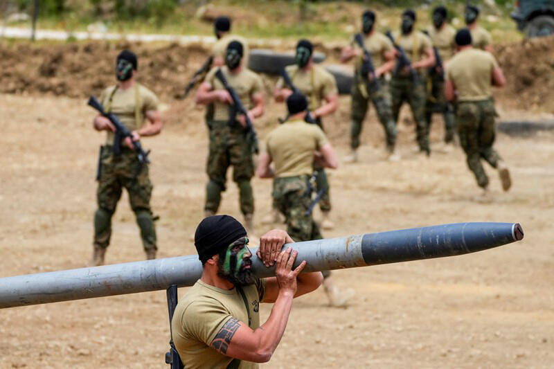 Hezbollah terrorist carrying a rocket 