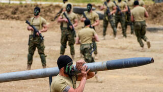 Hezbollah terrorist carrying a rocket 