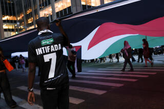 מפגין אנטי-ישראלי עם חולצה הקוראת לאינתיפאדה, ביום השנה השני למתקפת הטרור של חמאס