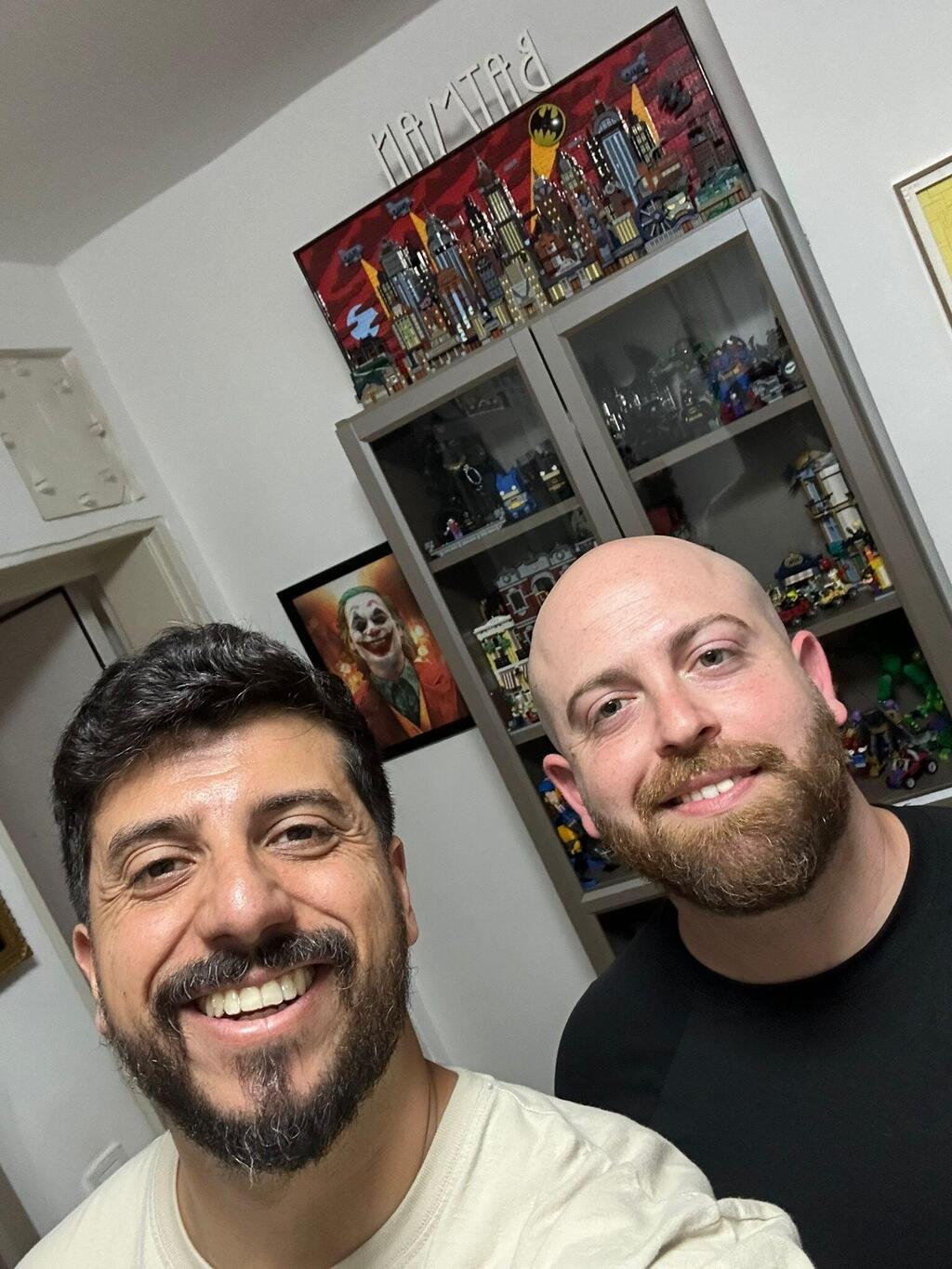 Stand-up comedian Matan Peretz, left, and People and Collectors podcast host Bar Gindy, right, smile during a visit at Peretz's LEGO collection room 