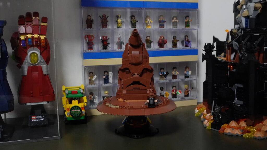 A LEGO replica of the Sorting Hat from the Harry Potter series is displayed alongside superhero minifigures and memorabilia at stand-up comedian Matan Peretz’s home 