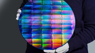 IBM researcher holding 300mm IBM Quantum Nighthawk wafer 