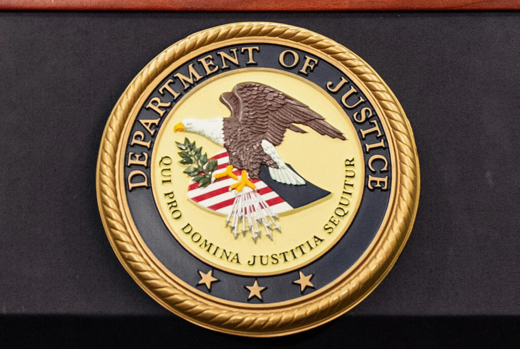 Department of Justice logo is seen on a podium during a press conference at the U.S. Attorney's Office in New York