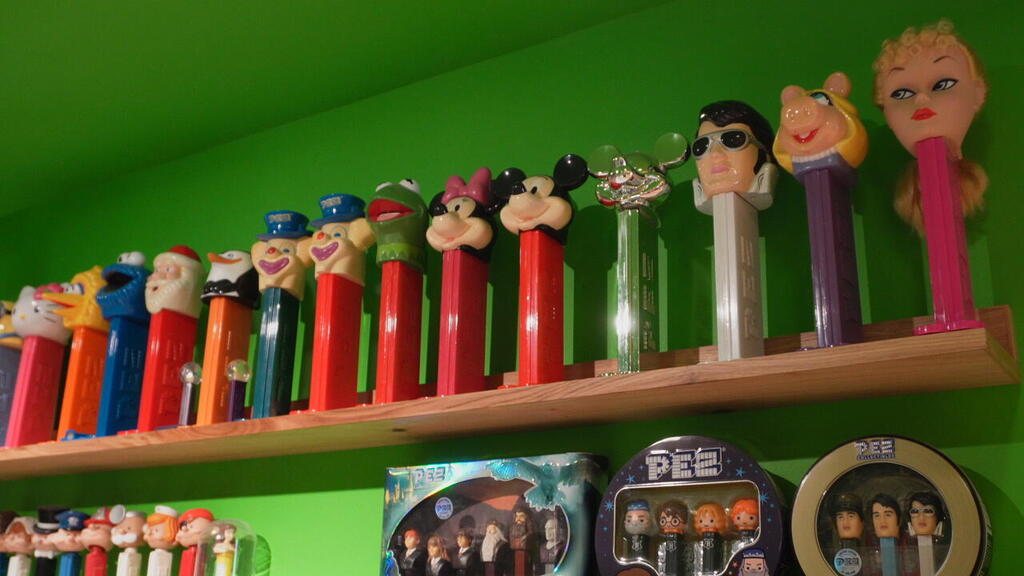Rows of vintage PEZ dispensers, part of Yaron Minkowski’s extensive collection, are displayed at his Toy & Nostalgia Museum in Jaffa