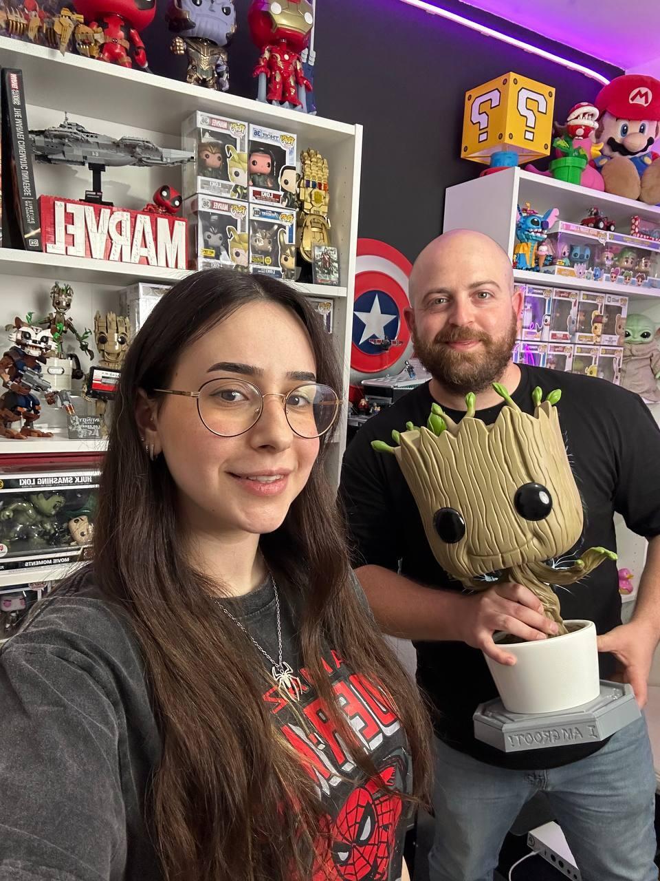 Lin Cohen and People and Collectors podcast host Bar Gindy pose with a Groot figure in Cohen’s pop culture-filled apartment in Ashkelon 