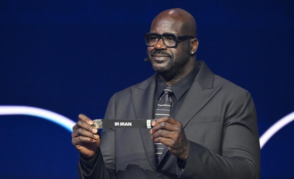 Shaquille O'Neal holds up Iran after drawing from a pot during the 2026 soccer World Cup draw 