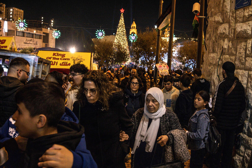 People walk through Nativity Square during a Christmas tree lighting ceremony in Bethlehem, West Bank, on December 6, 2025 (Photo: JOHN WESSELS / AFP) People walk through Nativity Square during a Christmas tree lighting ceremony in Bethlehem, West Bank, on December 6, 2025