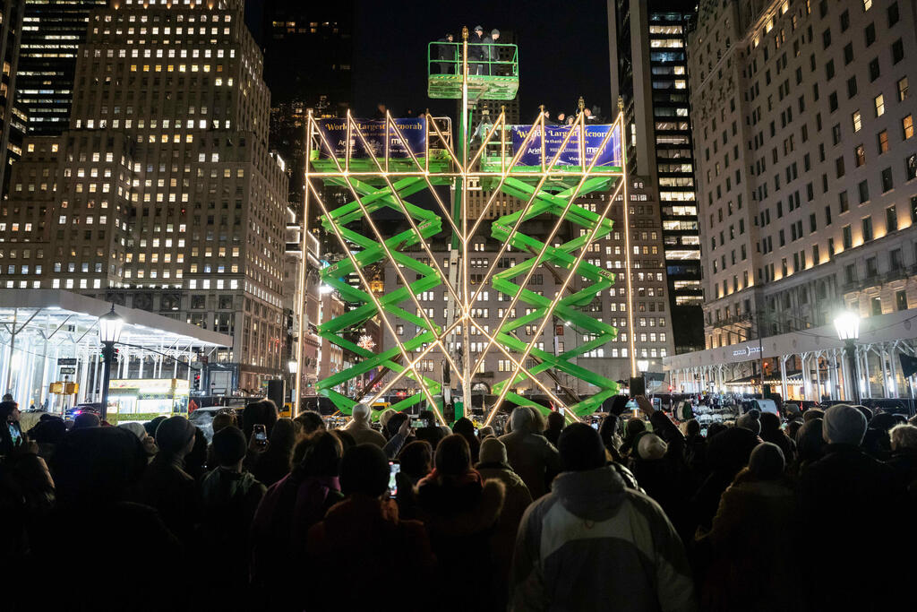 People gather to watch the lighting of the world's largest menorah on 5th Avenue by Central Park for the second night of Hanukkah (Photo: Yuki Iwamura/AP) People gather to watch the lighting of the world's largest menorah on 5th Avenue by Central Park for the second night of Hanukkah