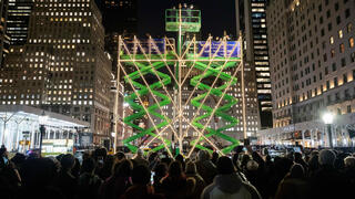 People gather to watch the lighting of the world's largest menorah on 5th Avenue by Central Park for the second night of Hanukkah 