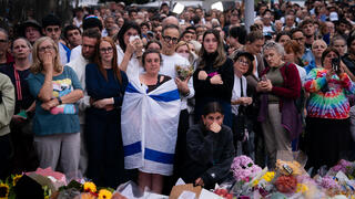 מחווה בזירת טבח סידני אוסטרליה בונדיי ביץ' עם דגל ישראל לקורבנות פיגוע ב חנוכה