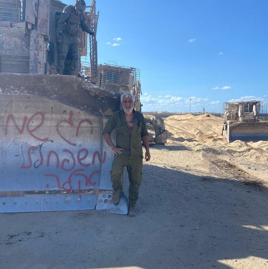 Hertzel Rahamim beside one of the heavy vehicles he transported in Gaza (Photo: Courtesy of Hertzel Rahamim) הרצל רחמים ליד אחד הכלים הכבדים שהוביל בעזה