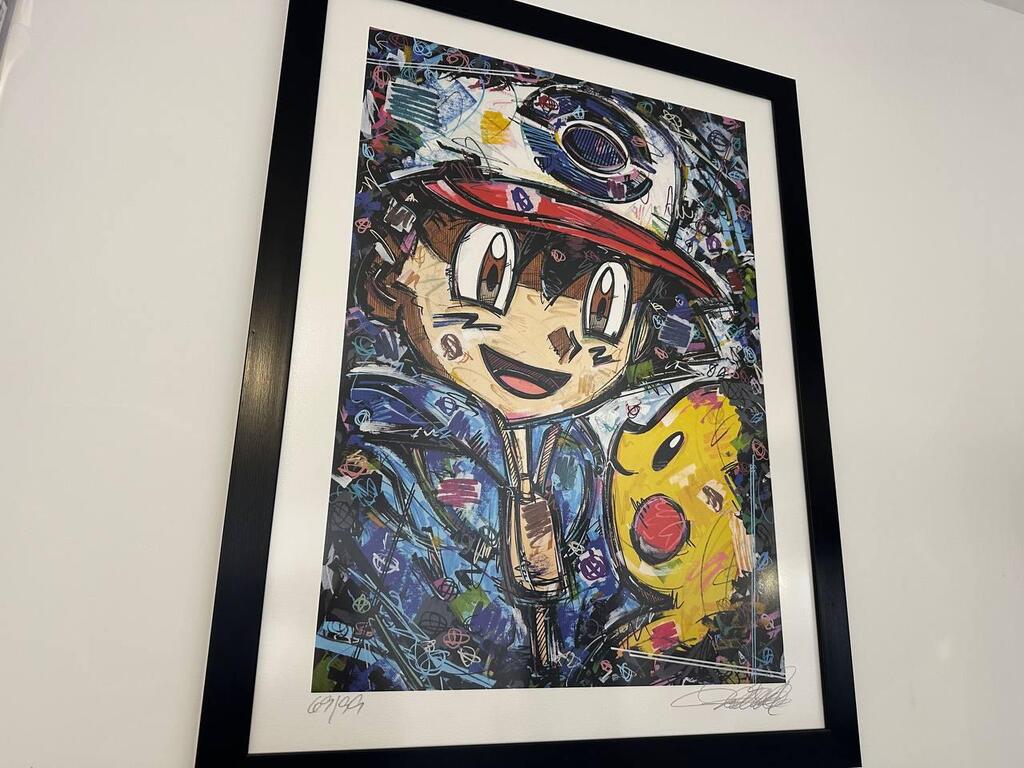 A framed artwork of Ash Ketchum and Pikachu hangs in Dor’s collection room, blending pop culture and personal nostalgia in Israel’s growing Pokémon collecting scene 
