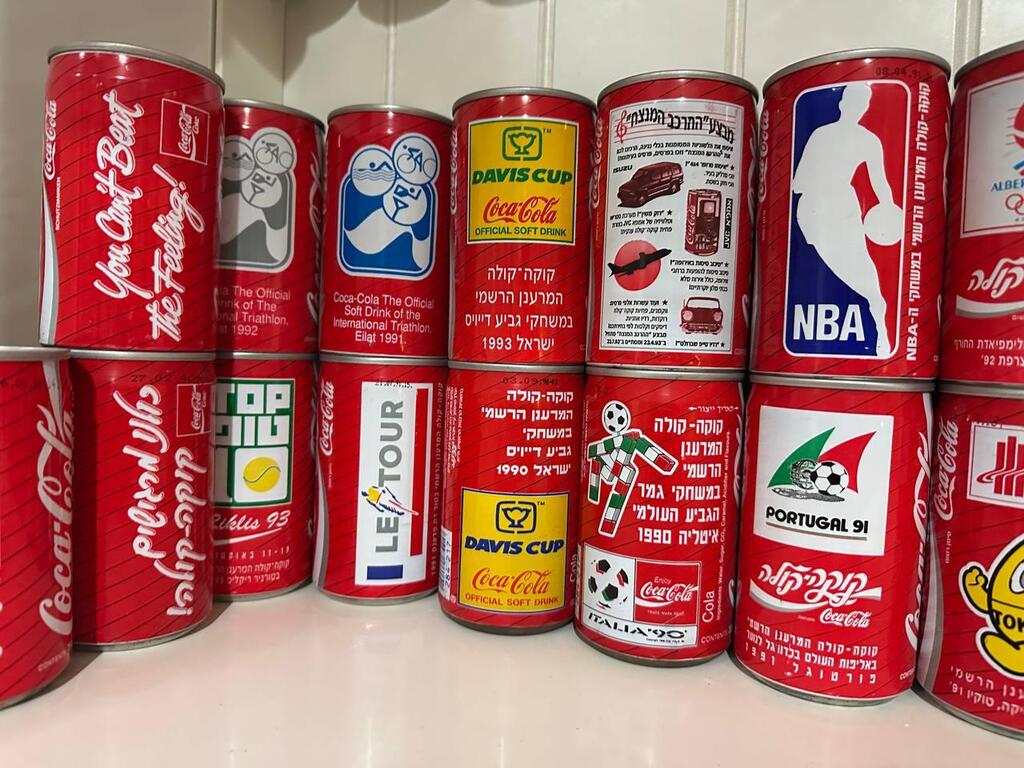 Commemorative Coca-Cola cans are displayed at the home of Israeli collector Ophir in Kibbutz Tzora. The collection focuses on limited-edition cans produced for sports tournaments, cultural events and advertising campaigns, mostly prior to the year 2000 