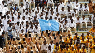 A student waves Somali national flag during a demonstration against Israel's recognition of Somaliland as an independent and sovereign state at the Mogadishu Stadium in Warta Nabada district of Mogadishu on Tuesday