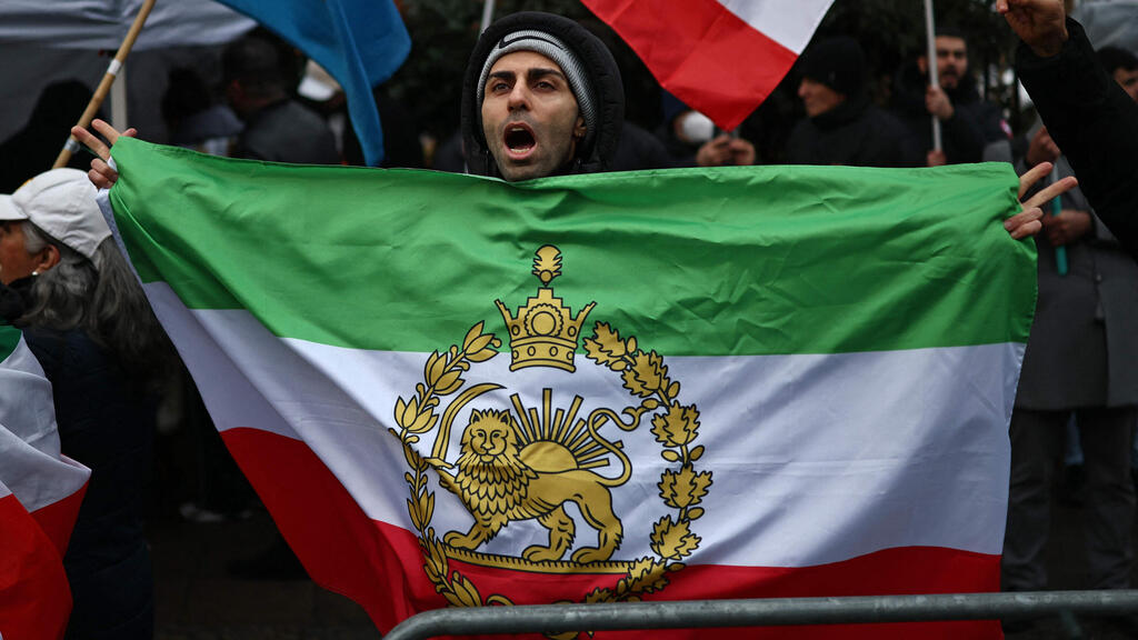 דגל השאה הקודם של איראן עם סמל האריה והשמש ב הפגנה לונדון 9 בינואר