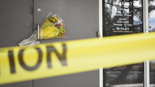 Caution tape and flowers cover the entrance to the Beth Israel Congregation, a synagogue that was set on fire early Saturday morning, on Monday, Jan. 12, 2026, in Jackson, Miss 