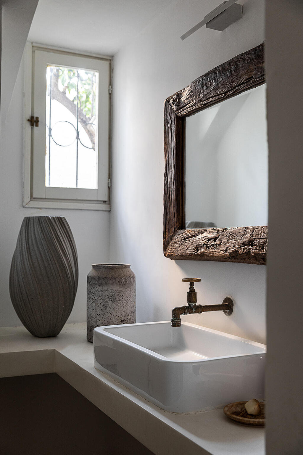 The mirrors are framed with collected driftwood (Photo: Gadi Yosef) בית בנווה צדק, עיצוב: נעמה רודין אשר