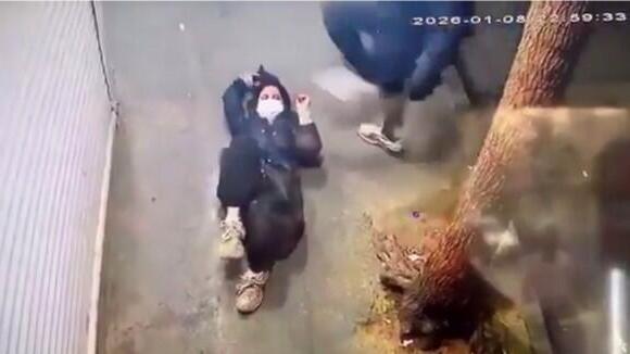 A female protester being attacked by paramilitary forces A female protester being attacked by paramilitary forces