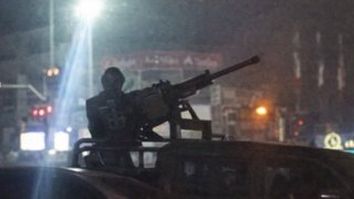 A regime agent is seen manning a machine gun during widespread street protests 