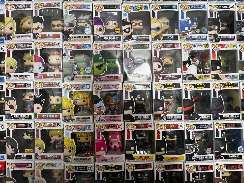 Batman-themed Pop! figures and articulated mech collectibles are part of Yarin’s curated display 