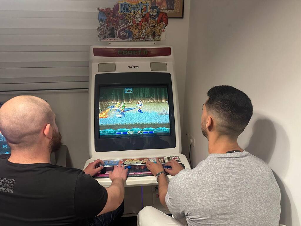 Bar Gindy, host of the People & Collectors podcast, left, and Or play on a Taito Egret II Japanese arcade cabinet in Or’s gaming room in Hadera (Photo: Bar Gindy) Bar Gindy, host of the People & Collectors podcast, left, and Or play on a Taito Egret II Japanese arcade cabinet in Or’s gaming room in Hadera