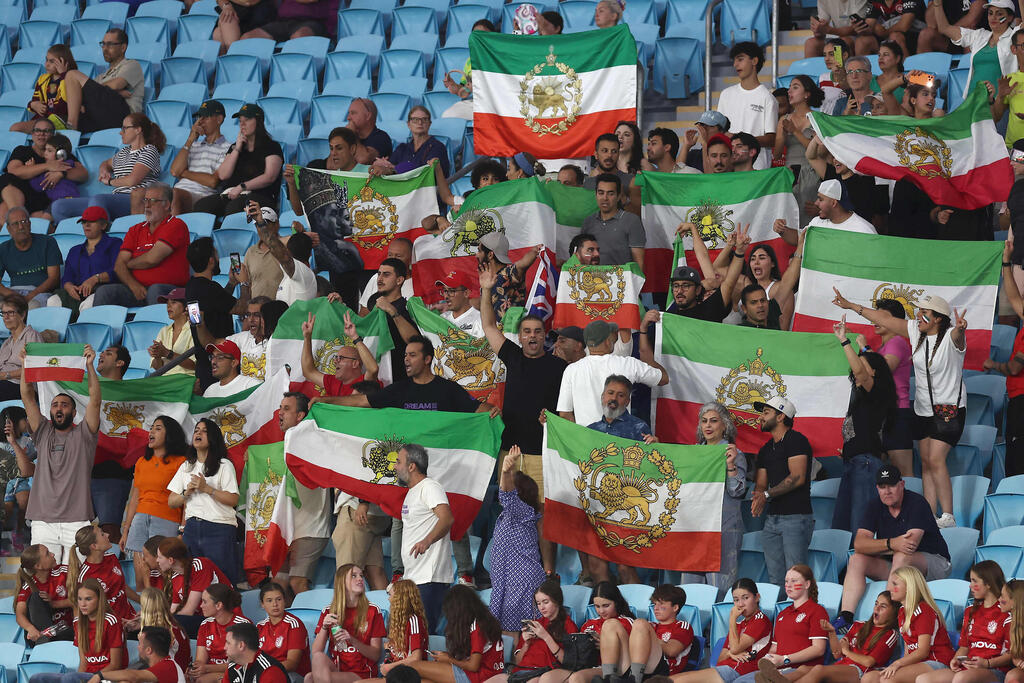Iran fans with the pre-Islamic Revolution era flag (Photo: Izhar Khan / AFP) אוהדי איראן עם הדגל הישן