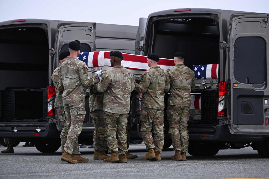 US Army soldiers at Dover Air Force Base carry the casket containing the remains of one of 6 US soldiers killed by an Iranian drone strike in Kuwait