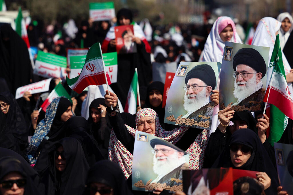 Women hold posters of slain leader Ayatollah Ali Khamenei during Friday noon prayers at the compound of the Mosalla mosque in Tehran on March 6, 2026.