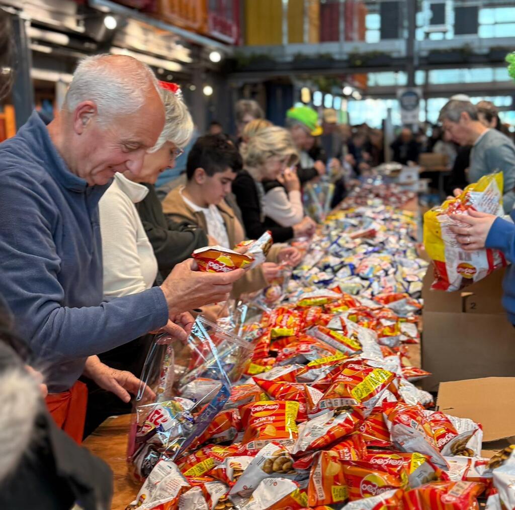 Volunteers with Sword of Iron Israel Volunteer Corp packing goods