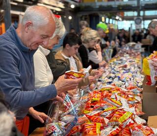 Volunteers with Sword of Iron Israel Volunteer Corp packing goods
