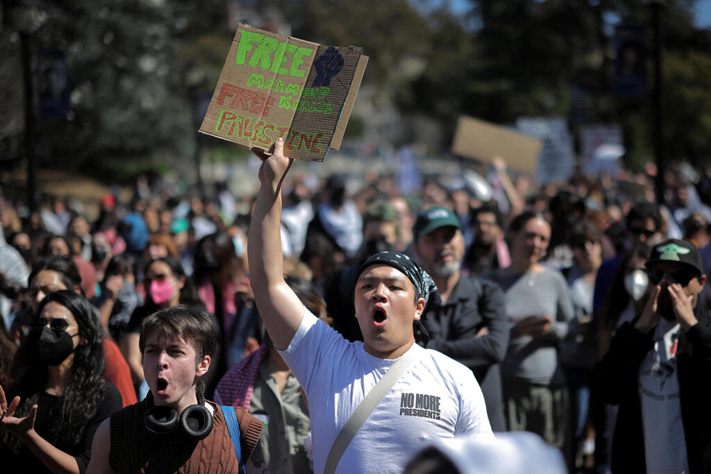 A demonstrator displays a sign as people attend a  Protest following the arrest by US immigration agents of Palestinian student protester Mahmoud Khalil at Columbia University, in Berkeley, California, U.S. March 11, 2025