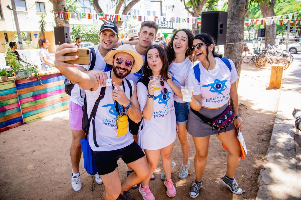 Young adults on a Birthright Israel trip pose for a selfie during an outdoor gathering in Tel Aviv, Israel (Photo: Birthright Israel) Young adults on a Birthright Israel trip pose for a selfie during an outdoor gathering in Tel Aviv, Israel