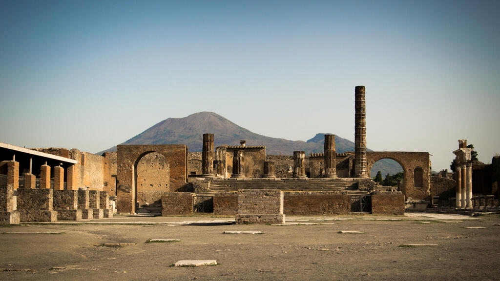 Remains of the ancient city of Pompeii, with Mount Vesuvius in the background, which erupted in 79 AD and buried the city and its surroundings (Photo: Johannes Eber) שרידי העיר העתיקה פומפיי, כשברקע הר הגעש וזוב שהתפרץ בשנת 79 לספירה וקבר את העיר ותושביה