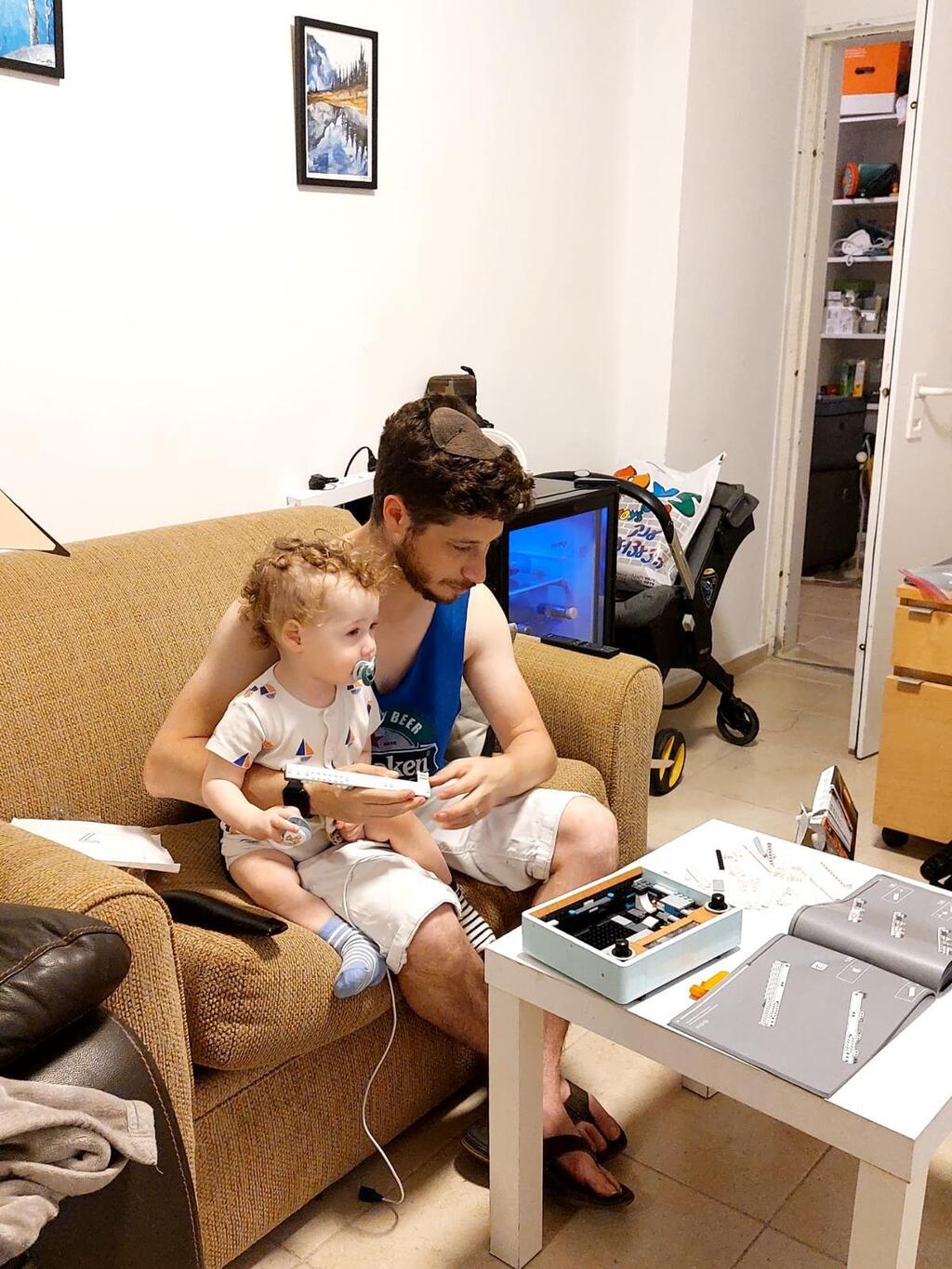 Elliott sits with AJ while assembling a LEGO set at home, where building sessions became a source of calm during the toddler’s treatment (Photo: Courtesy) Elliott sits with AJ while assembling a LEGO set at home, where building sessions became a source of calm during the toddler’s treatment