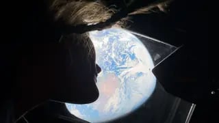 Christina Koch peers out of one of the aircraft's windows