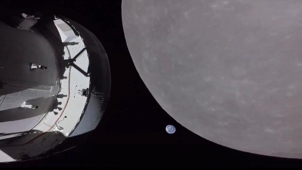 החללית, הירח וגם כדור הארץ (נקודה כחולה קטנה) בתמונה