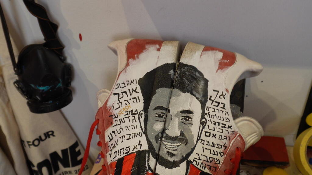 A customized pair of Adidas Gazelle sneakers painted by Sahar Haba in tribute to Hersh Goldberg-Polin is displayed at the entrance to his studio in Tel Aviv